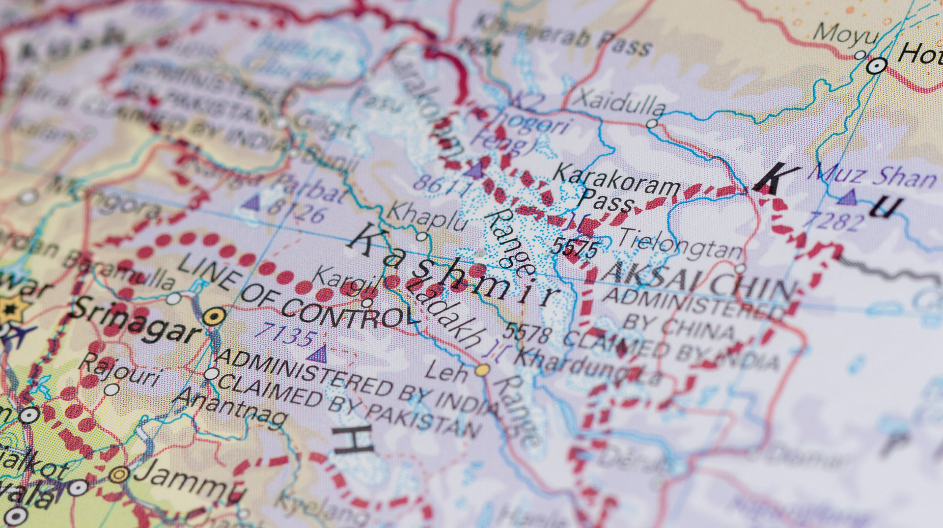Close-up on the map of Kashmir, a region divided among three countries — Pakistan, India, and China — due to an ongoing territorial