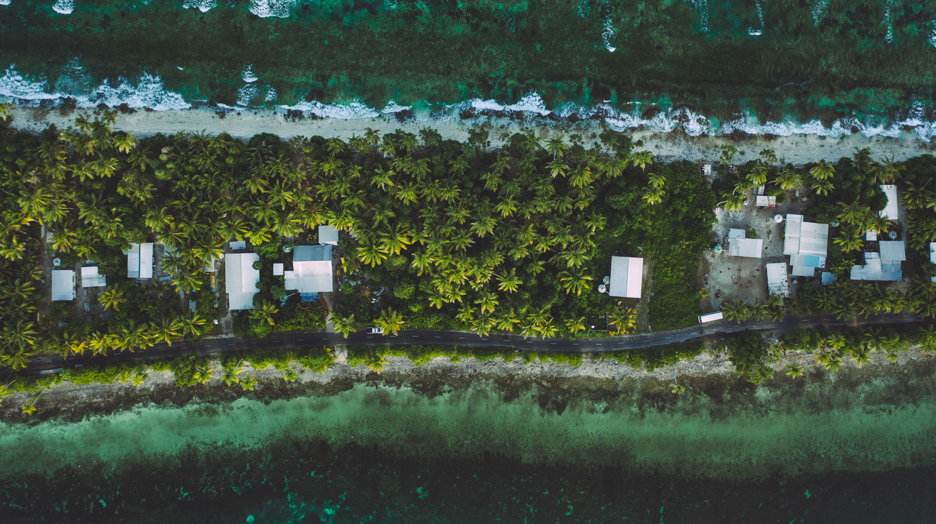  Tuvalu (Funafuti) aerial shot of one of the thinest part of the island where the ocean and lagoon can be seen together . 