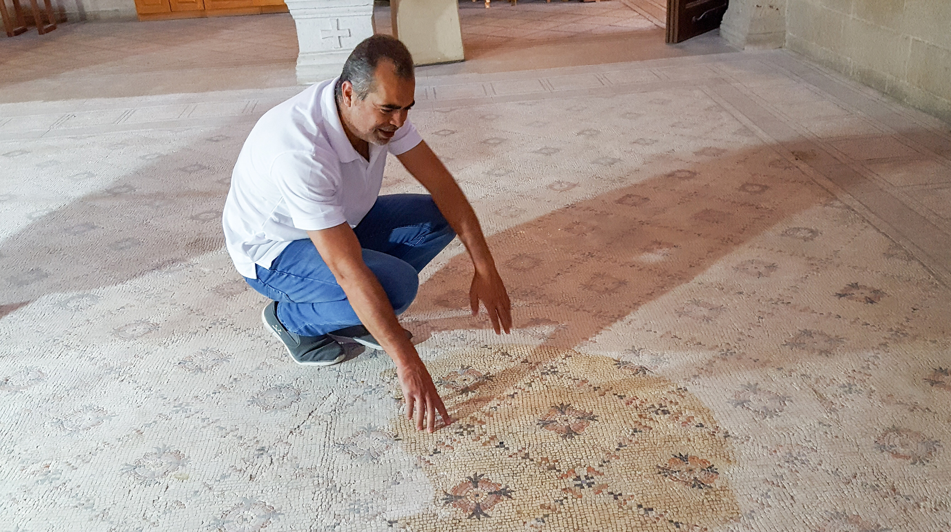Raed Khalil, Direktor der Restaurierungsfirma "Mosaic Center Jericho", zeigt am 1. Juni 2023 ein Stück des restaurierten Bodenmosaiks in der Brotvermehrungskirche des Benediktinerklosters Tabgha (Israel).