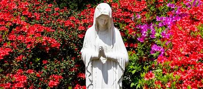 Statue of the Virgin Mary with flowers