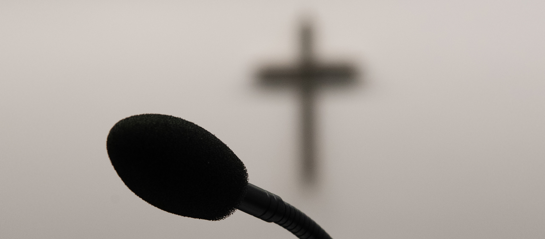 A microphone in front of a cross