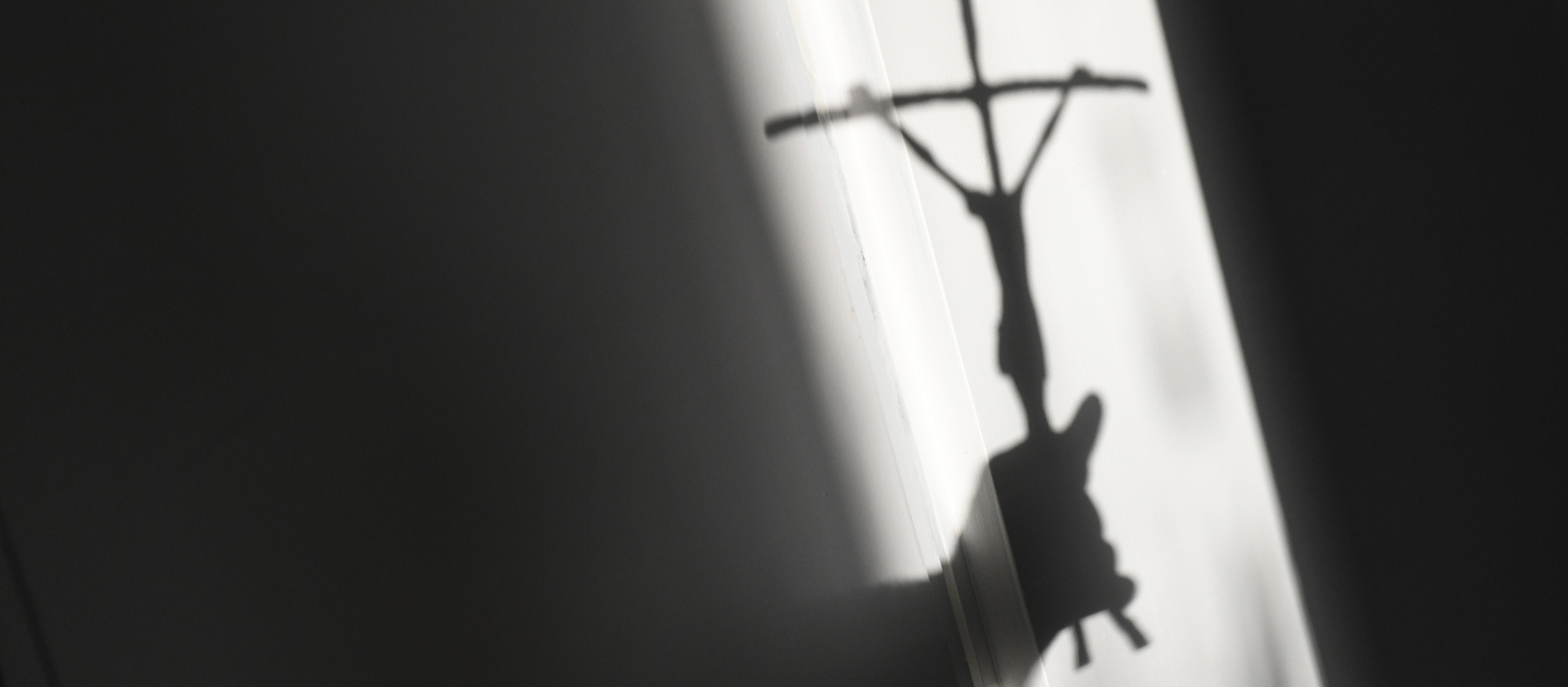 Shadow of a crucifix on a wall