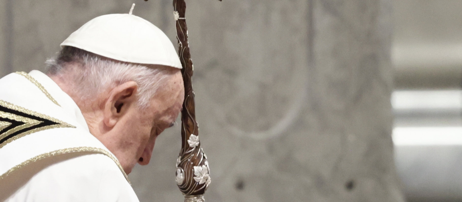 Pope Francis leans on a cross staff